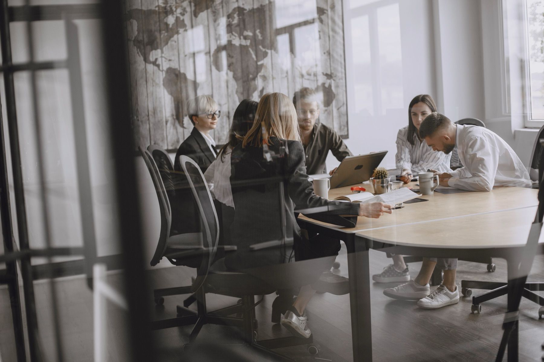 Team collaborating around a meeting table in a modern office