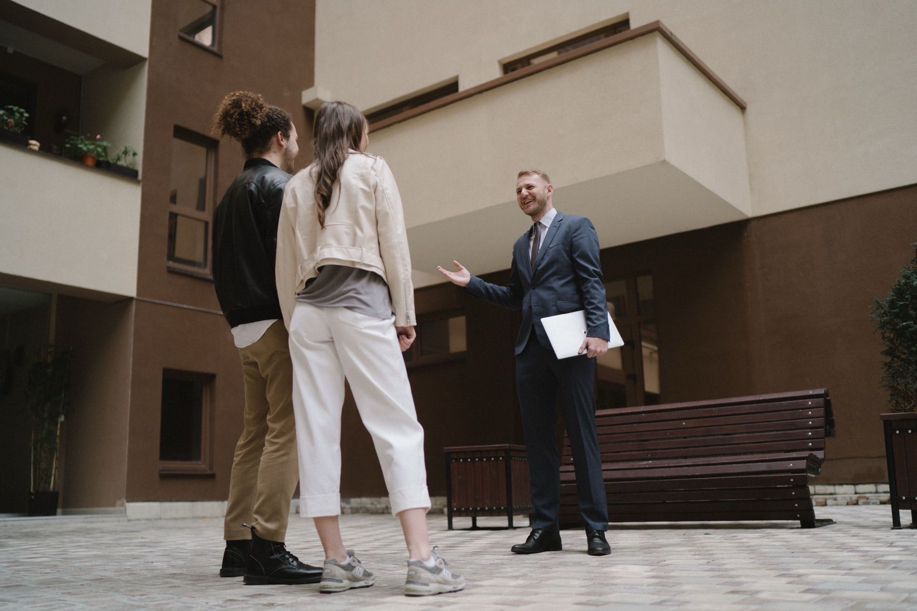 Property professional meeting clients outside a residential building